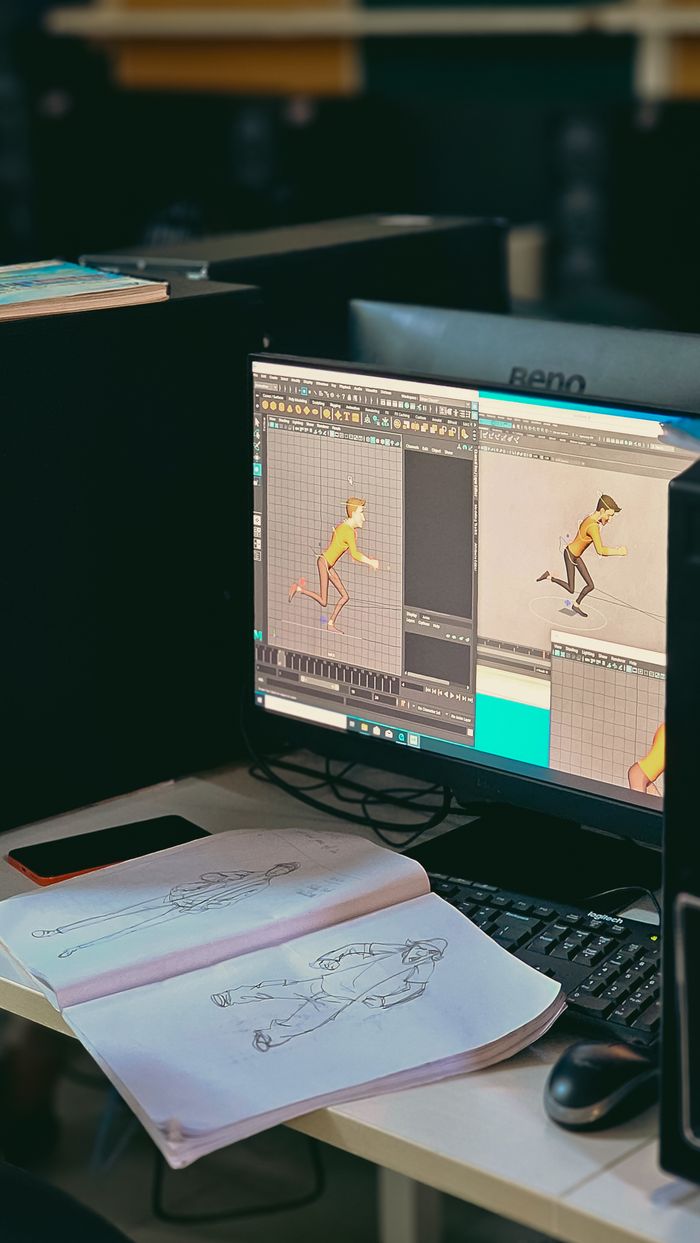 services-02 Animation studio workspace with sketches and digital character design on screen.